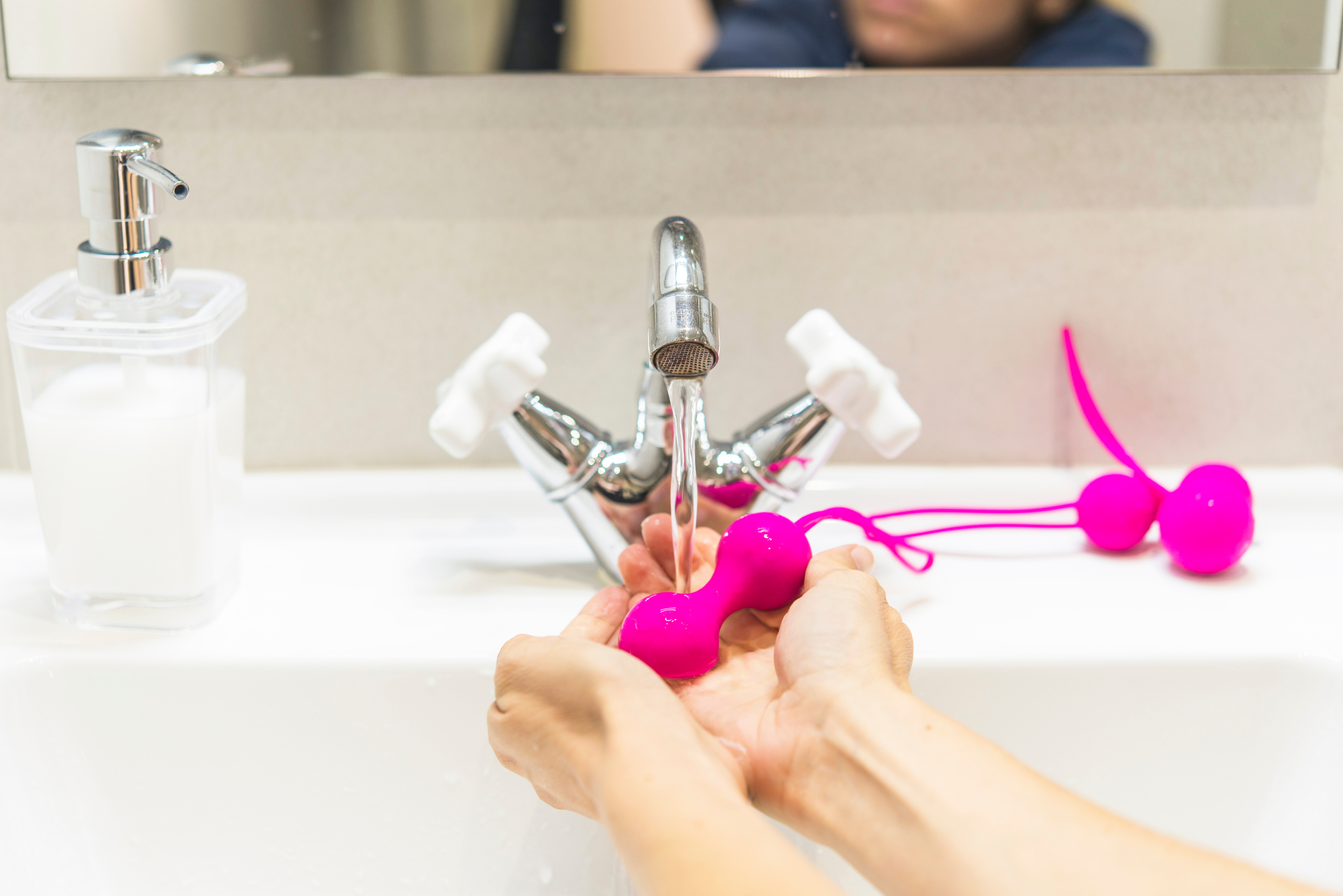 Person Washing Kegel Balls in a Sink