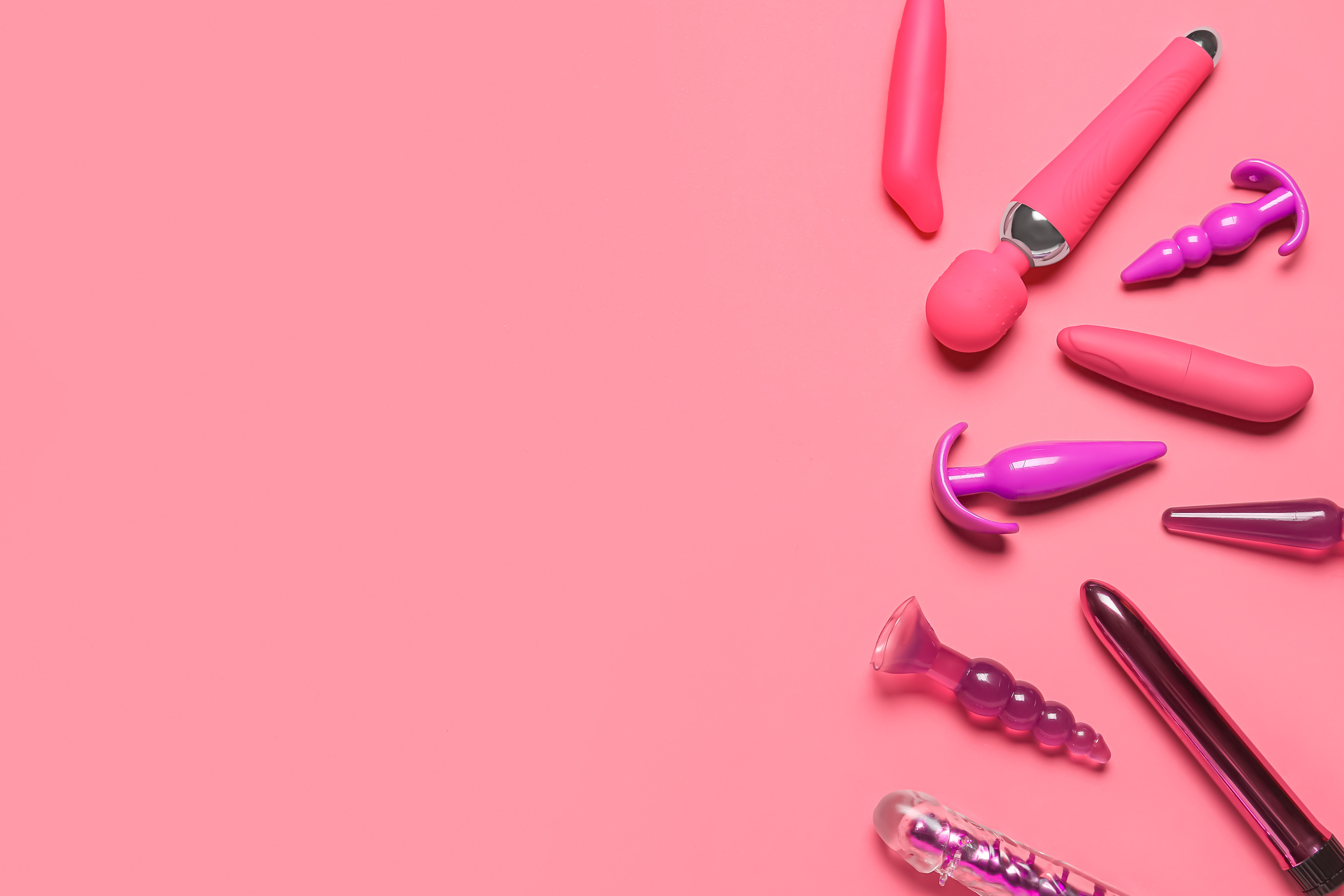 Vibrators with  Plugs on Pink Background